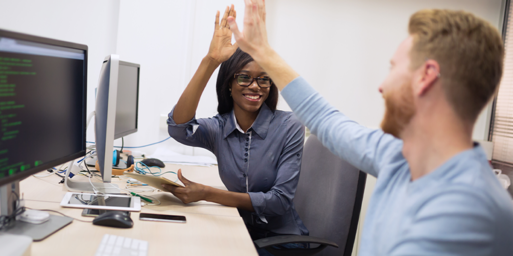 coworkers high-fiving in front of blog