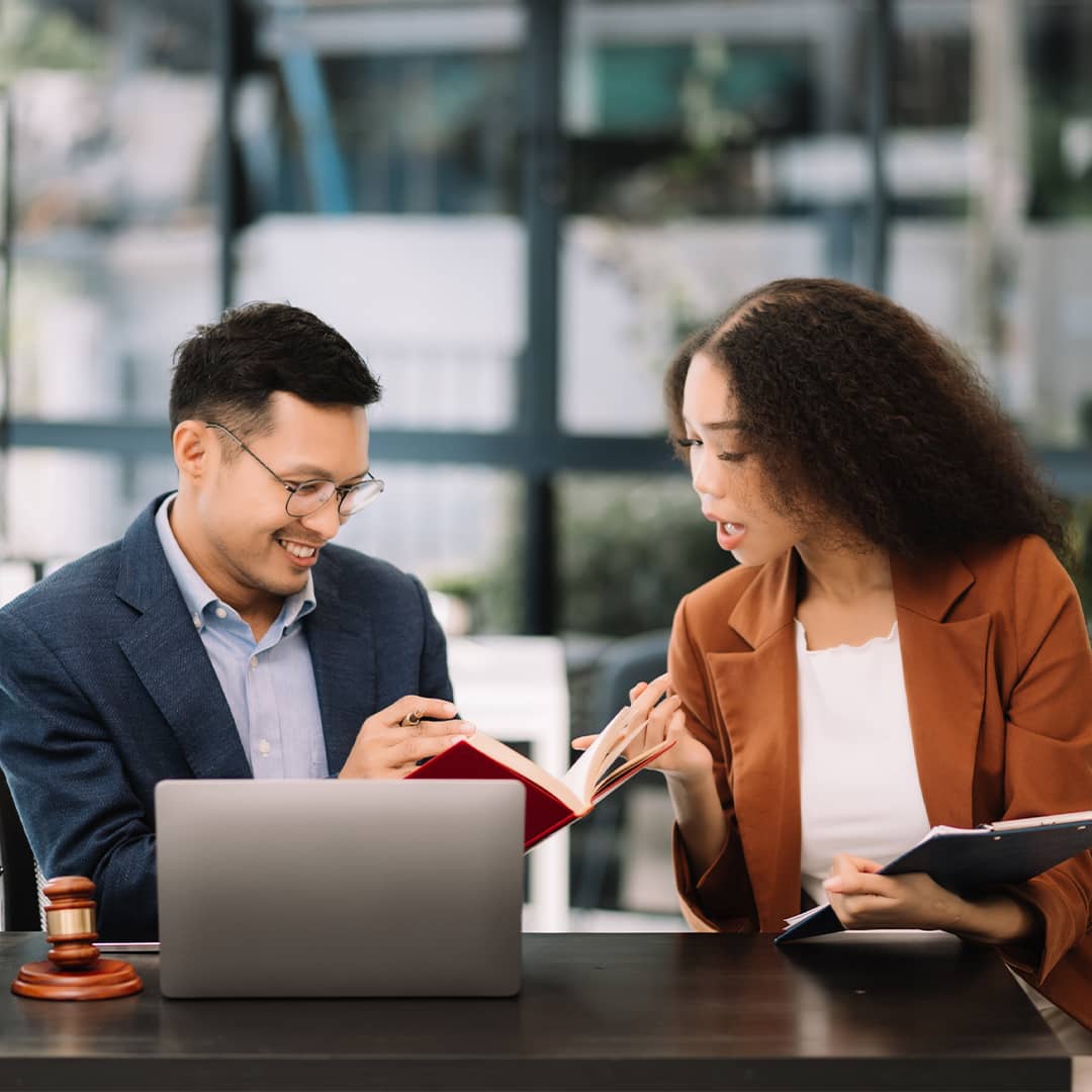 A young woman and her business lawyer discuss compliance issues