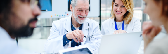 Group-of-doctors-looking-at-X-ray-on-medical-conference Group of doctors looking at X-ray on medical conference